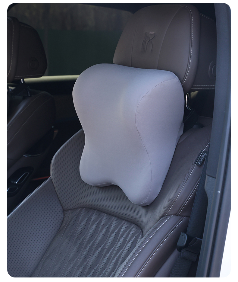 Gray massage pillow installed in a car